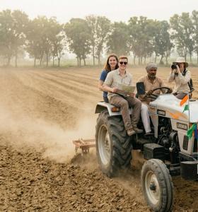 a group of people riding on the back of a tractor at Joon Farm in Kot Qāsim