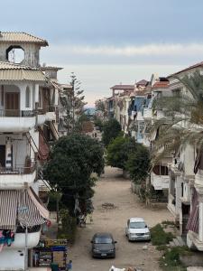 a city street with cars parked in front of buildings at Ras elbar Palace in Ras El Bar