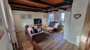a living room with a couch and a table at Rosenhaus in Kappeln