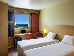 Rúm í herbergi á Ibis Cancun Centro