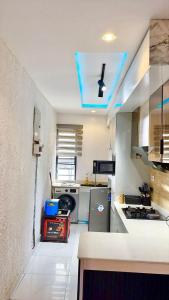 a kitchen with a blue light on the ceiling at Premium Height in Ikate