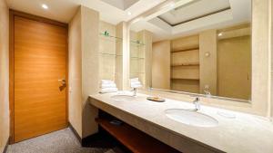 a bathroom with two sinks and a large mirror at Villa TIGMIZEN - 10CH - Piscine chauffée et Spa - Marrakech in El Aouina +135 photos