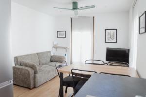 a living room with a couch and a table at Apartaments Angelina in La Pobla de Segur