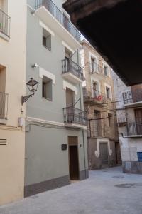 a white building with balconies on the side of it at Apartaments Angelina in La Pobla de Segur