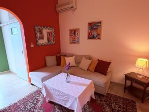 a living room with a couch and a table at Art & Motion Union - Guest Room 4 in Andros