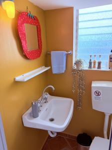 a bathroom with a sink and a mirror at Art & Motion Union - Guest Room 4 in Andros