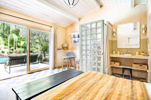 a bedroom with a large glass door and a table at Moulin de Lassalle in Linxe +44 photos