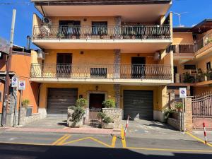 an apartment building with two garage doors on a street at I Pantani in Schisò