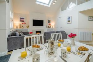 a dining room and living room with a table with food at 1 Bed in Lytham St. Annes oc-86044 in Saint Annes on the Sea