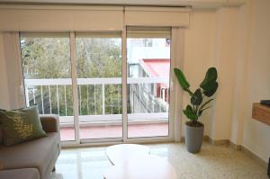 a living room with a couch and a large window at Las Heras in Bahía Blanca
