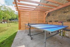 a ping pong table in front of a shed at Le clos de la ferme in Chervey