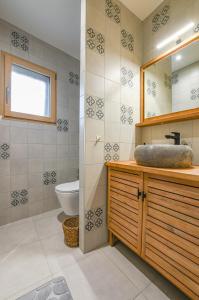 a bathroom with a sink and a toilet at La ferm'hier in Balnot-sur-Laignes +10 photos