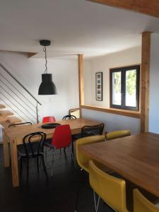 a dining room with wooden tables and chairs at Cozy chalet with panoramic views in Leysin in Leysin