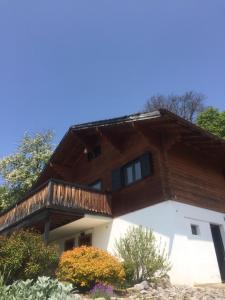 a house with a balcony on top of it at Cozy chalet with panoramic views in Leysin in Leysin