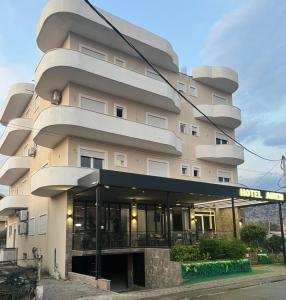 a large building with a building at Airen Hotel Velipoje in Velipojë