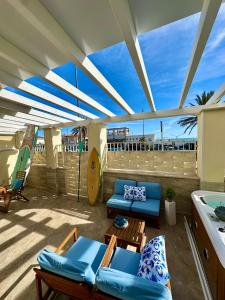 a patio with blue chairs and tables on a balcony at Blu Suite Ostia in Lido di Ostia