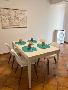 a white table with chairs and cups on it at I Pantani in Schisò