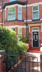 a brick house with a gate in front of it at Avalon B&B Scarborough in Scarborough +22 photos