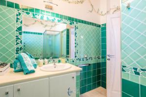 a bathroom with a sink and a mirror at Blue Moon in Castelsardo +56 photos
