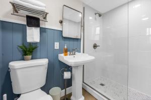 a bathroom with a toilet and a sink and a shower at Dune Drift in Cocoa Beach