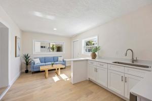 a kitchen and living room with a blue couch at Anchor House in Cocoa Beach