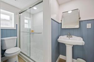 a bathroom with a toilet and a sink and a shower at Anchor House in Cocoa Beach