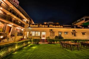a hotel new mumbai with a lawn in front of it at Hotel New Mamta by SSH 350 Metres from Nakki Lake in Mount Ābu