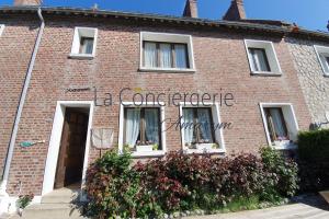 a red brick building with a sign on it at Le Maluthina Maison Familiale au Hourdel entre Mer & Nature in Cayeux-sur-Mer