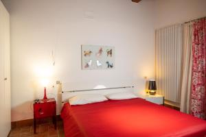 a bedroom with a red bed with a red blanket at Lilium B&B Villa Patrizia - Con piscina e parcheggio by Mamo Florence in Itri