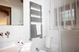 a white bathroom with a sink and a mirror at Lilium B&B Villa Patrizia - Con piscina e parcheggio by Mamo Florence in Itri +35 photos