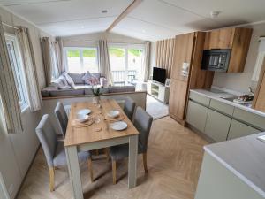 a kitchen and dining room with a table and chairs at The Oaks 2 Bedrooms in Northwich +57 photos