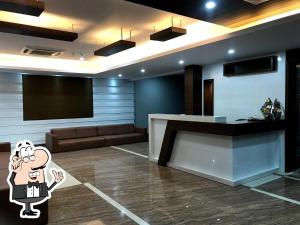 a lobby with a bar and a podium in a room at Hotel Satkar in Amalāpuram