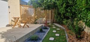 a garden with a table and a chair in it at Le cabanon du plaisir in Montpellier