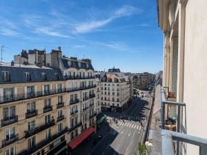 a view from a balcony of a city with buildings at Charmant appartement au cœur de Paris in Paris