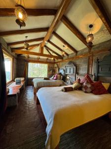 a bedroom with two beds in a room at Hacienda Rumiloma in Quito