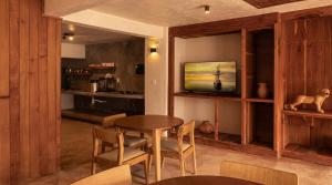 a dining room with a table and chairs and a television at Casa Chati Hostal Boutique in San Cristóbal de Las Casas +16 photos