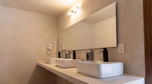 a bathroom with three sinks and a mirror at Casa Chati Hostal Boutique in San Cristóbal de Las Casas