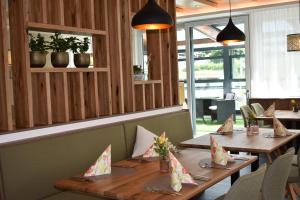 a dining room with wooden tables and chairs at Hotel Kleißl in Oberperfuss +77 photos