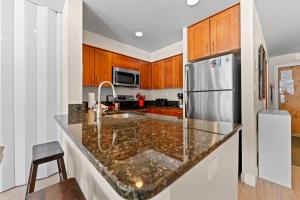 a kitchen with a stainless steel refrigerator and wooden cabinets at Lakeside #1496 in Keystone