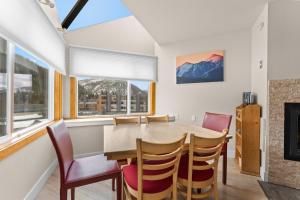 a dining room with a table and chairs and a fireplace at Lakeside #1496 in Keystone