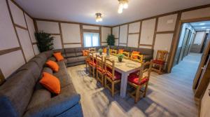 a living room with a couch and a table and chairs at La Casita de Lucia in Trescasas