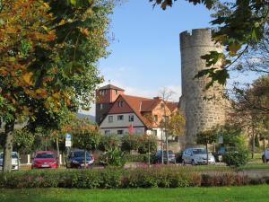 a castle with cars parked in a parking lot at Frau Holle-Land-Hotel Witzenhausen in Witzenhausen