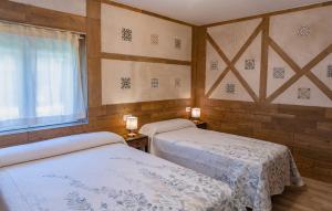 a bedroom with two beds and a window at La Casita de Lucia in Trescasas +40 photos