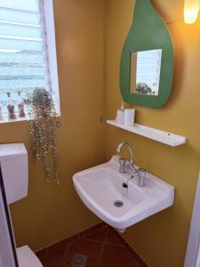 a bathroom with a sink and a mirror at Art & Motion Union - Guest Room 5 in Andros