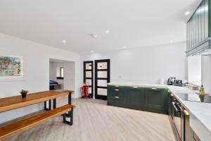 a kitchen with white walls and green cabinets at Flour Mill House - Pitkerro Mill in Dundee