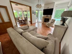 a living room with a couch and a dining room at Villa Magnetic in Baošići