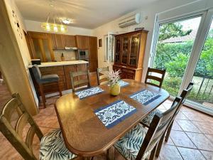 a kitchen and dining room with a wooden table and chairs at Villa Magnetic in Baošići