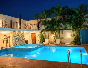 a swimming pool in a villa at night at M Residence in Accra