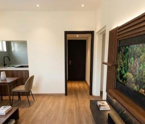 a living room with a flat screen tv and a kitchen at M Residence in Accra +3 photos