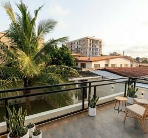 a balcony with a view of a palm tree at M Residence in Accra